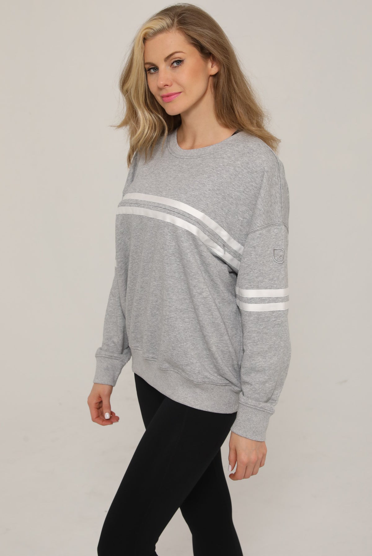 Side view of the Celine Nursing Pullover in heather gray, highlighting the subtle logo detail near the hem.