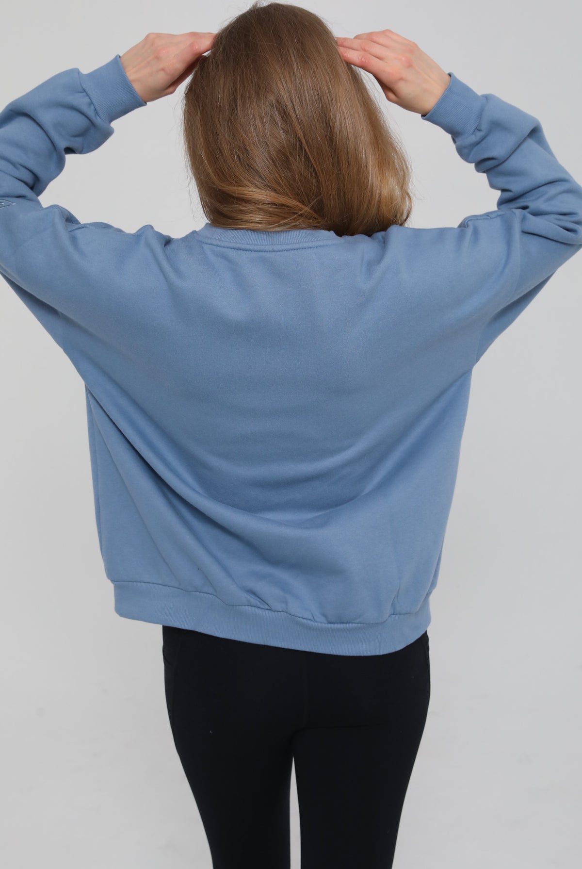 Back view of the Isabella Nursing Sweatshirt in chambery blue, showcasing the clean lines and comfortable, contoured shape, sweat and milk