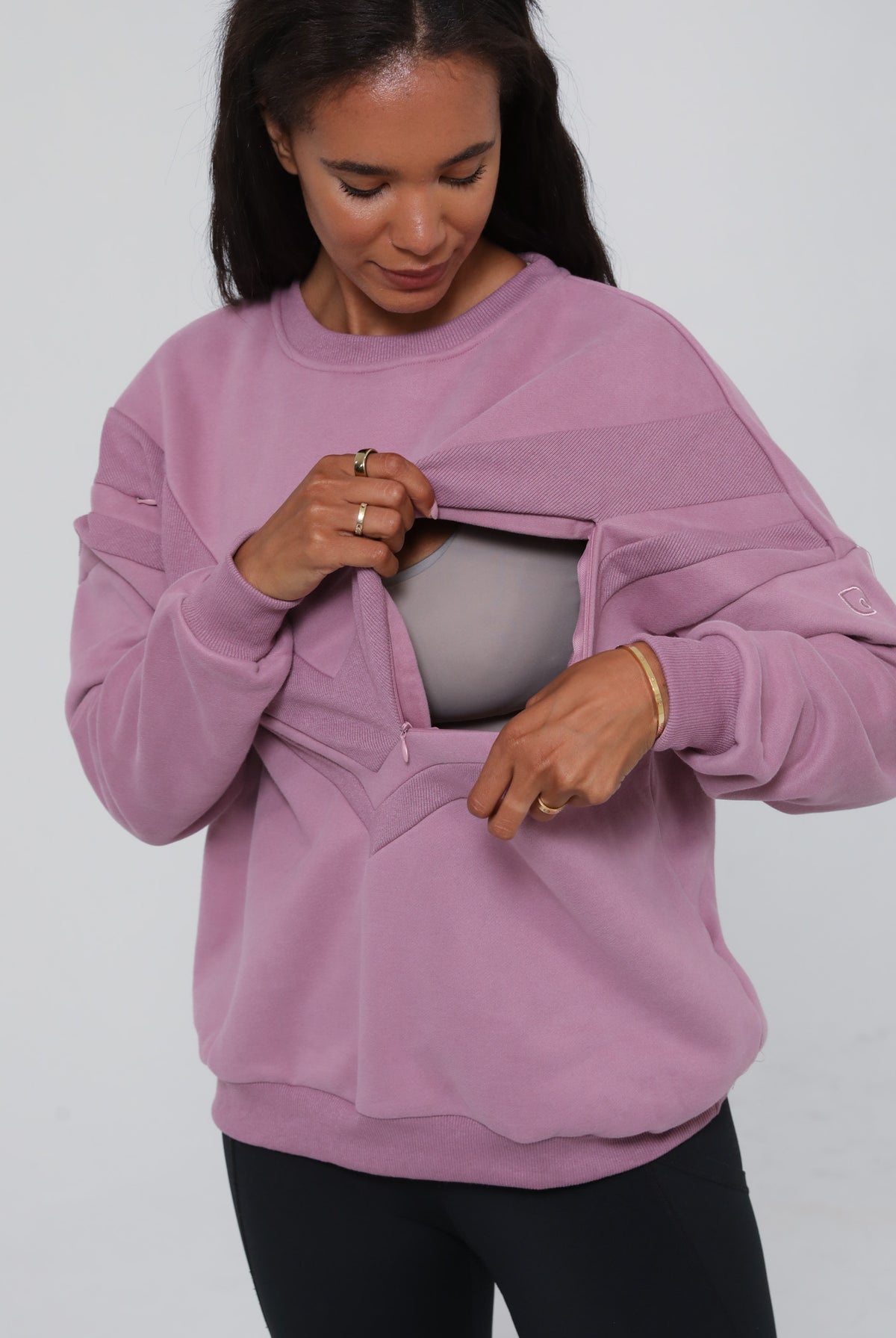 Close-up of the Isabella Nursing Sweatshirt in mulberry with side zipper being opened, showing discreet nursing access. Sweat and Milk