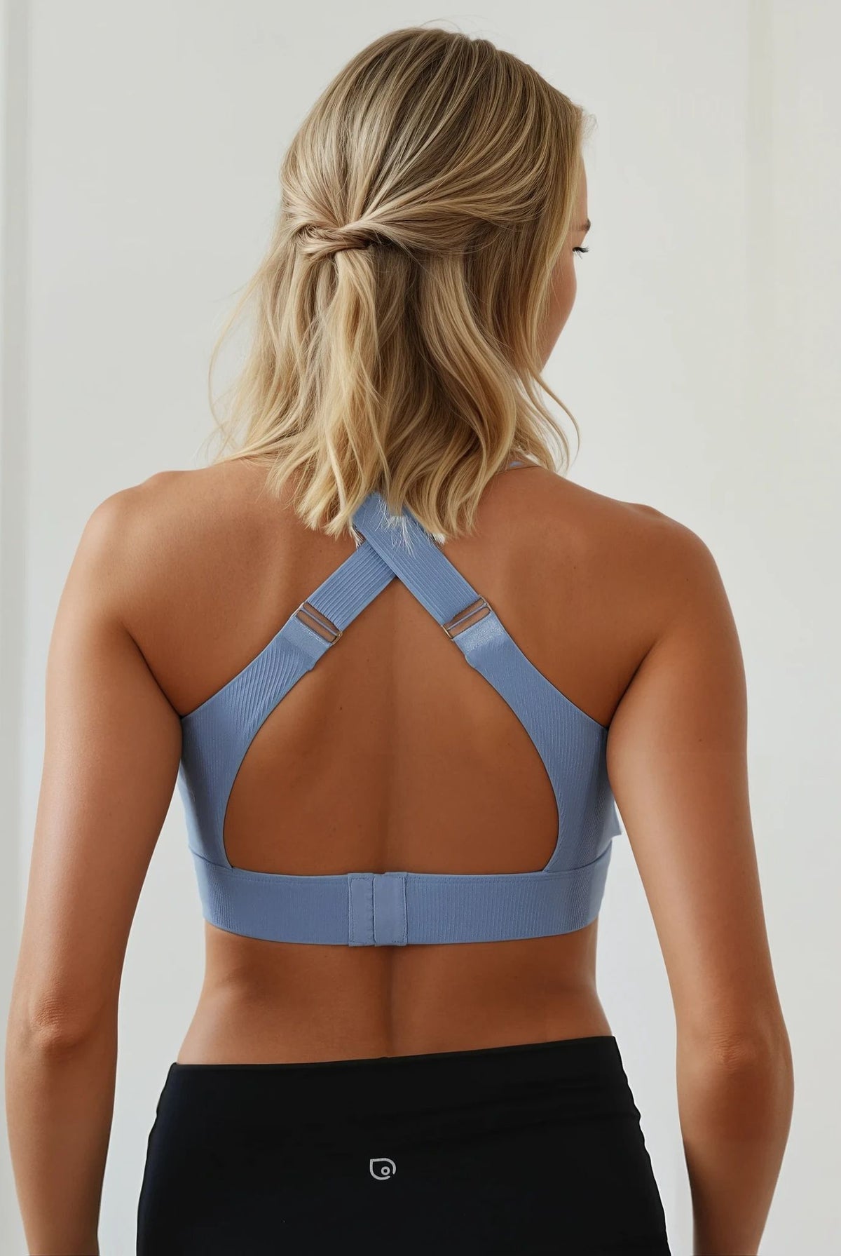 A mom wearing a Sweat and Milk's Venice 1 Lint Stone colored high impact nursing sports bra, back shot, showing the adjustable wide straps