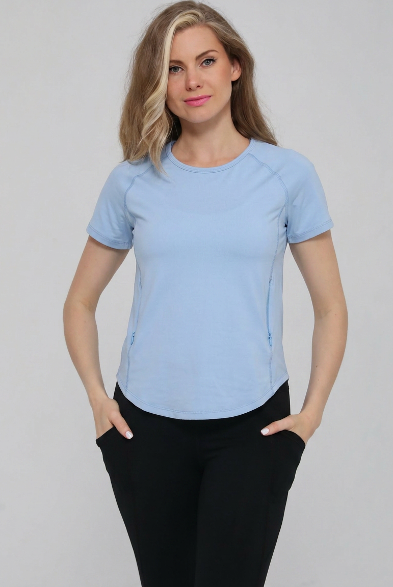 Mira running nursing top with dual zippers for easy access, light blue color, on model, front shot. Sweat and milk
