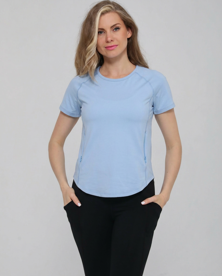 Mira running nursing top with dual zippers for easy access, light blue color, on model, front shot. Sweat and milk