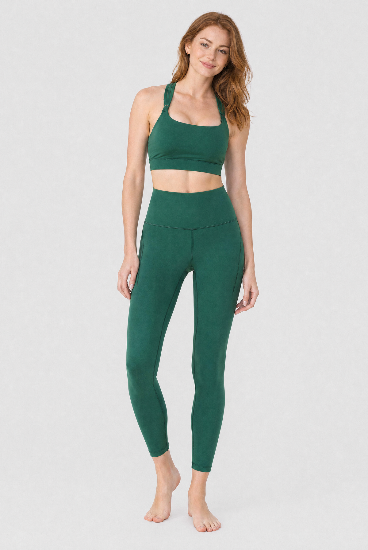 a model wearing a set of pine green colored activewear, a nursing sports bra and a pair of leggings with pocket, front shot