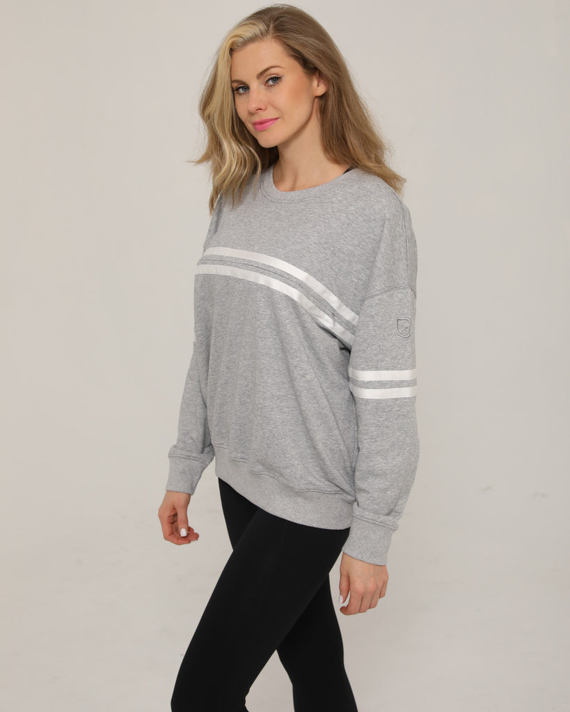 Side view of the Celine Nursing Pullover in heather gray, highlighting the subtle logo detail near the hem.