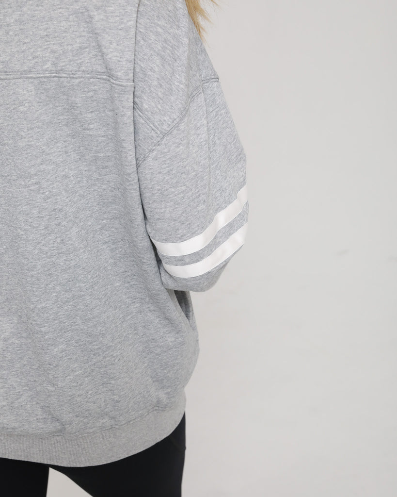Close-up of the Celine Nursing Pullover sleeve, featuring two subtle tonal stripe details for a sporty accent