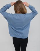 Back view of the Isabella Nursing Sweatshirt in chambery blue, showcasing the clean lines and comfortable, contoured shape, sweat and milk