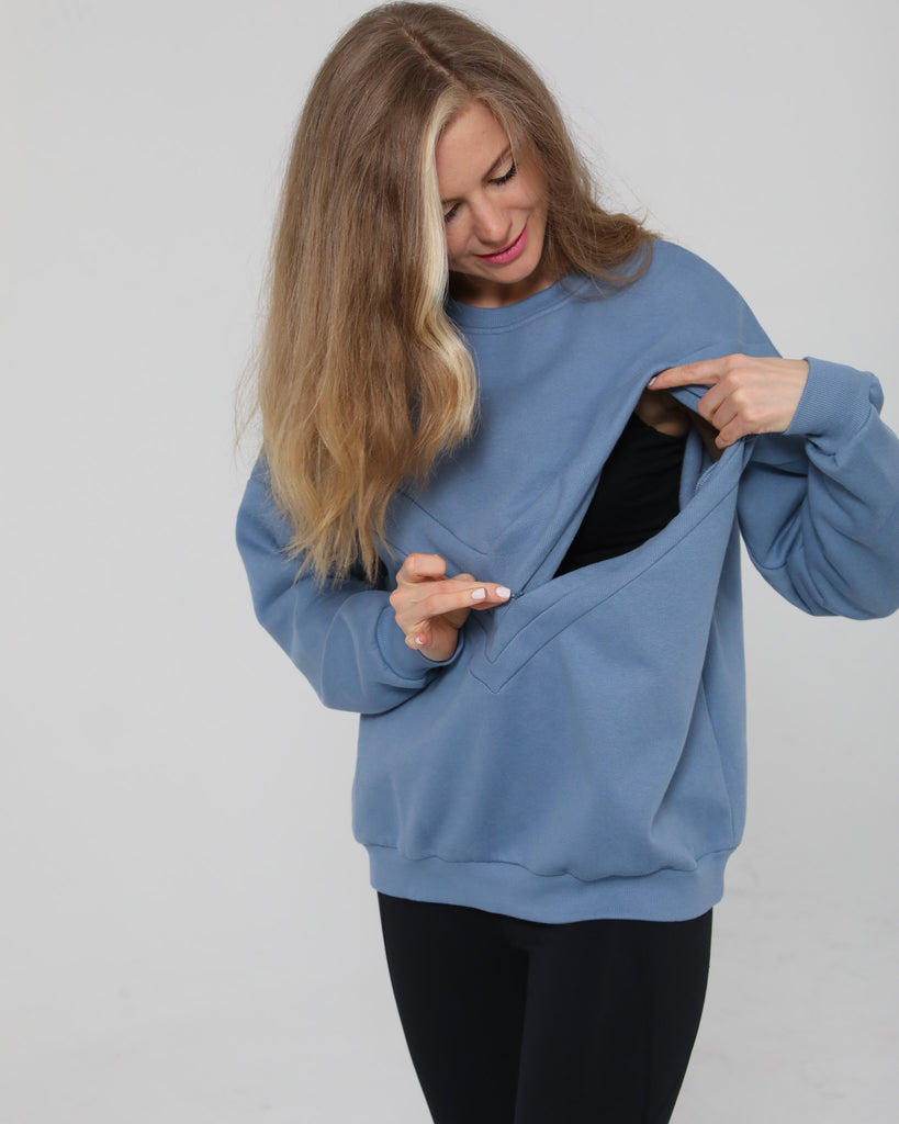 Close-up of the Isabella Nursing Sweatshirt in chambery blue with side zipper being opened, showing discreet nursing access, Sweat and Milk