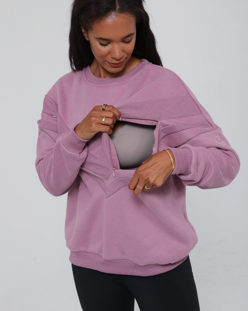 Close-up of the Isabella Nursing Sweatshirt in mulberry with side zipper being opened, showing discreet nursing access. Sweat and Milk