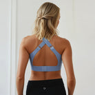 A mom wearing a Sweat and Milk's Venice 1 Lint Stone colored high impact nursing sports bra, back shot, showing the adjustable wide straps