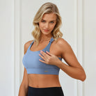 A mom wearing a Sweat and Milk's Venice 1 Lint Stone colored high impact nursing sports bra, demonstrating the clipping down to nurse feature