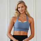 A mom wearing a Sweat and Milk's Venice 1 Lint Stone colored high impact nursing sports bra, demonstrating the wearable pumps feature