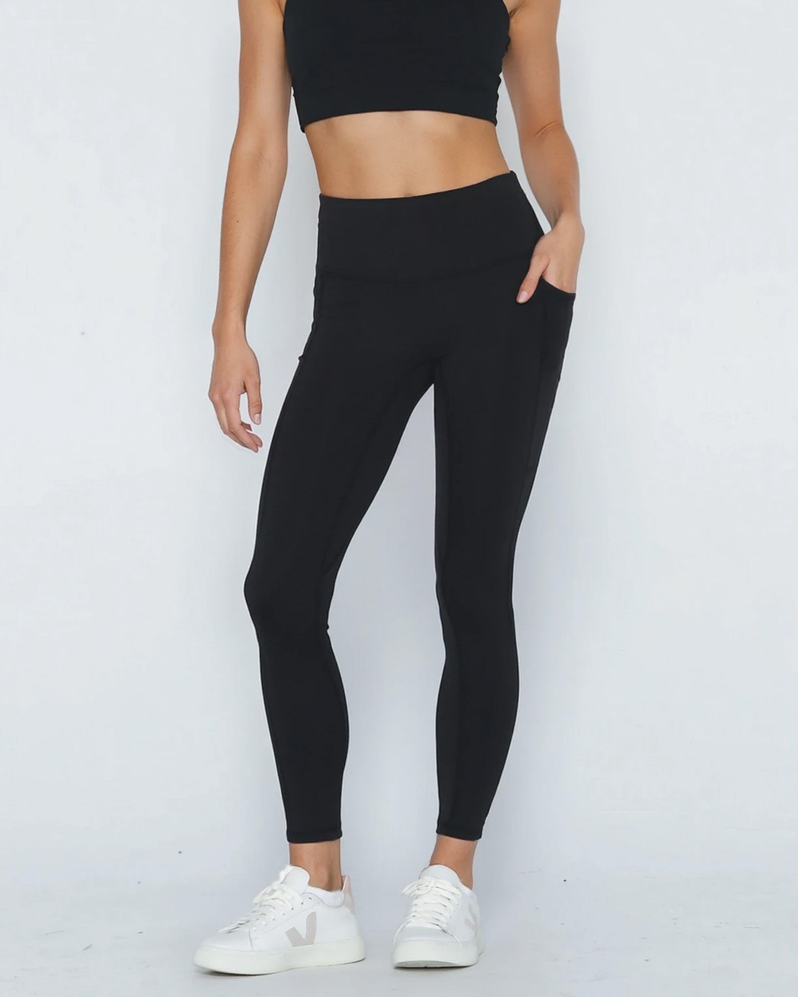 Postpartum ultra high waisted leggings, sweat and milk, with pockets, noir, front shot with both hands in pockets, half body