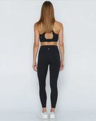Postpartum ultra high waisted leggings, sweat and milk, with pockets, noir, back view shot with hands in pocket, full body
