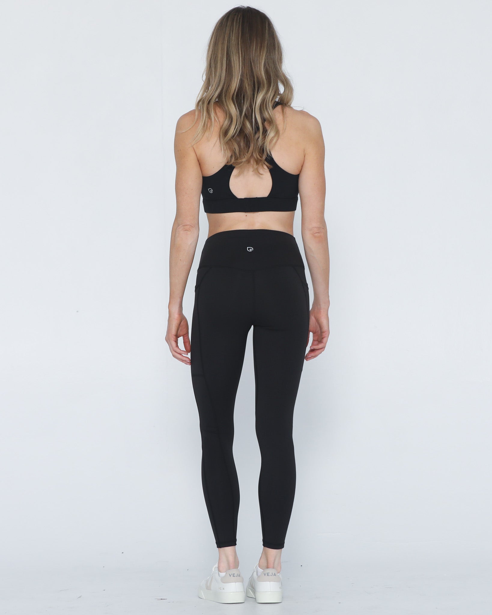 Postpartum ultra high waisted leggings, sweat and milk, with pockets, noir, back view shot with hands in pocket, full body