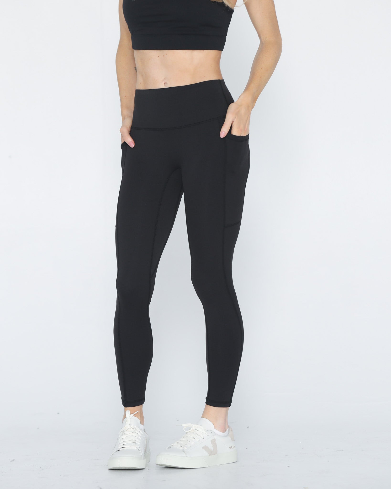 Postpartum ultra high waisted leggings, sweat and milk, with pockets, noir, front shot with both hands in pockets, half body