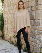 a woman wearing a cashmere poncho in black, nursing cover, noir, stroller blanket, travel cover, sweat and milk