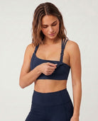 Chloe 5 running nursing sports bra with built in cups, black, non removable pads, high support, strappy back, adjustable band, nursingshot on model