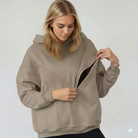Nursing hoodie, oversized, organic cotton, invisible zipper, sweat and milk, front shot, unzipping to show the breastfeeding access