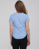 Mira running nursing top with dual zippers for easy access, light blue color, on model, front shot showing laser holes patterns. Sweat and milk